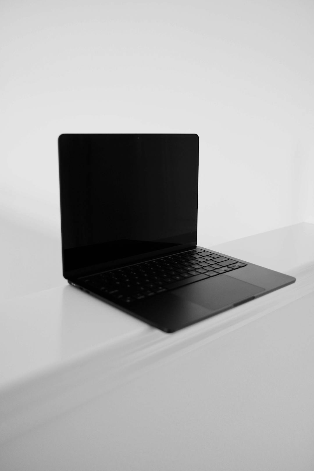 A black Macbook against a white backdrop