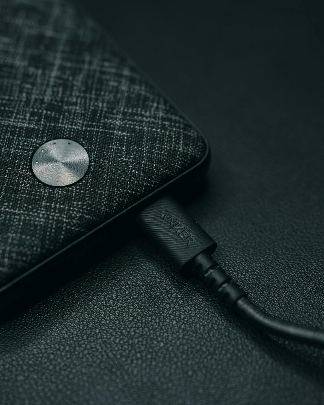 A powerbank charging, with the brand 'ANKER' printed on the cable