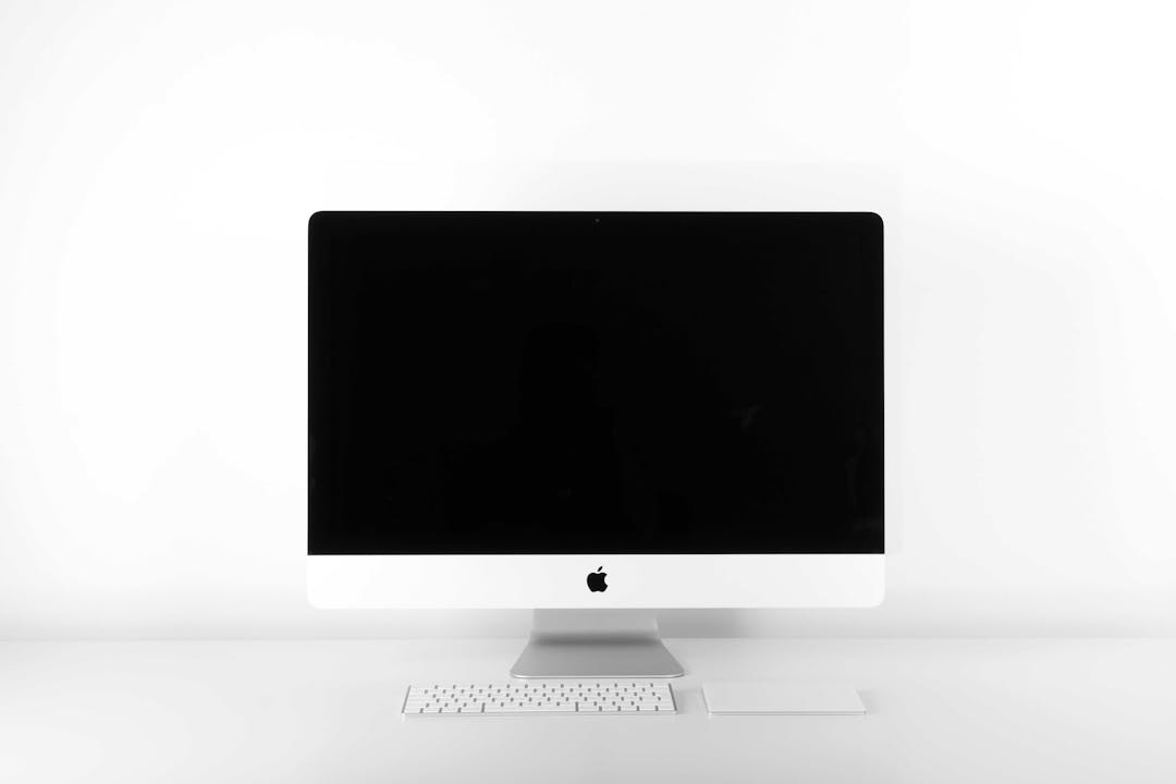 An iMac, with a keyboard and keypad, against a white backdrop